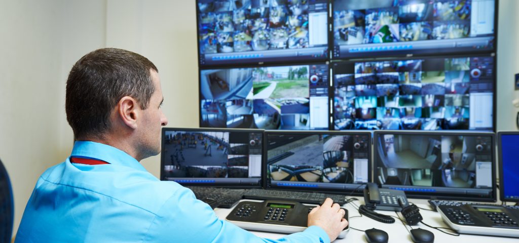 security guard watching video monitoring surveillance security system